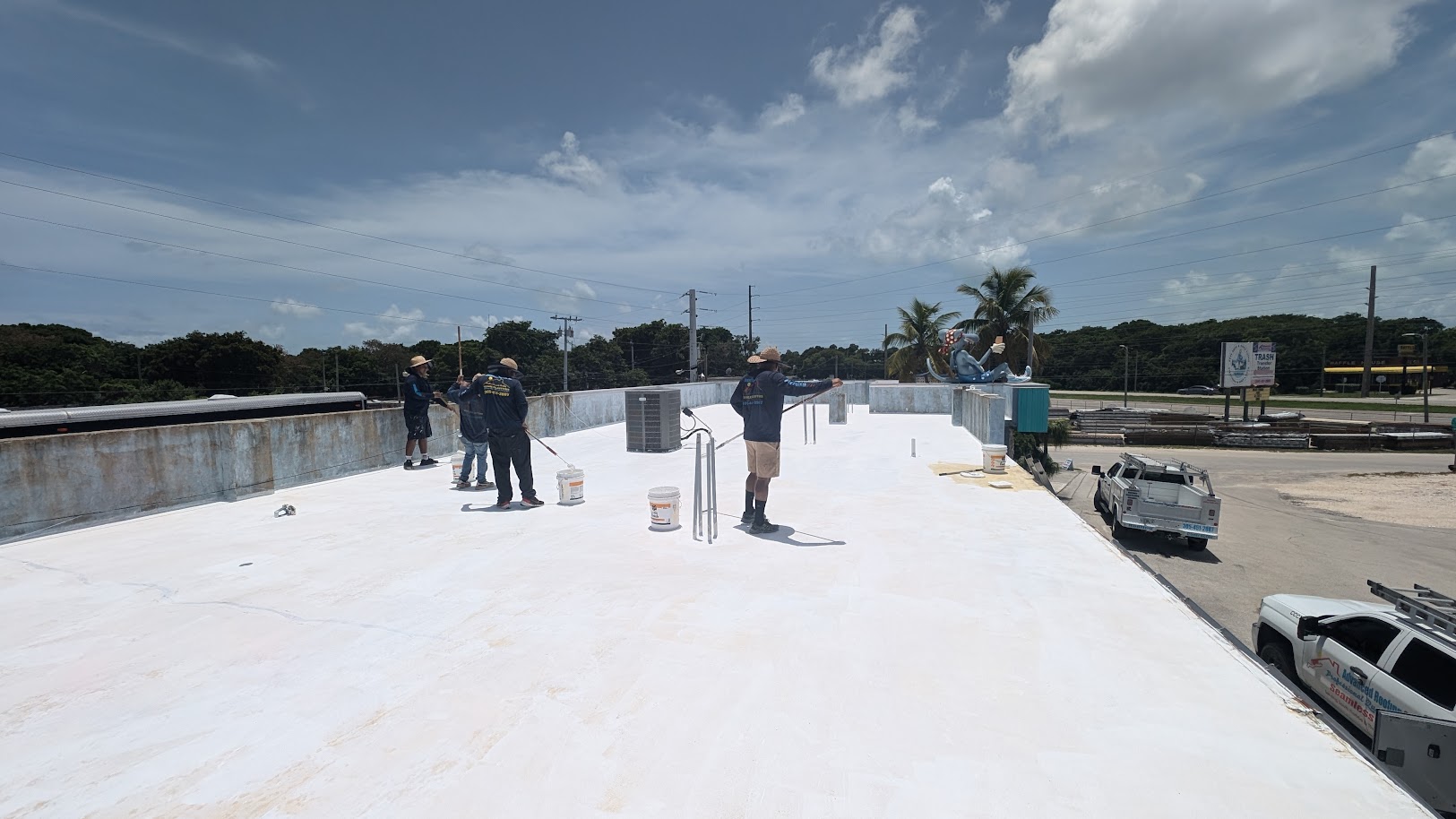 Large commercial flat roof with workers performing installation
